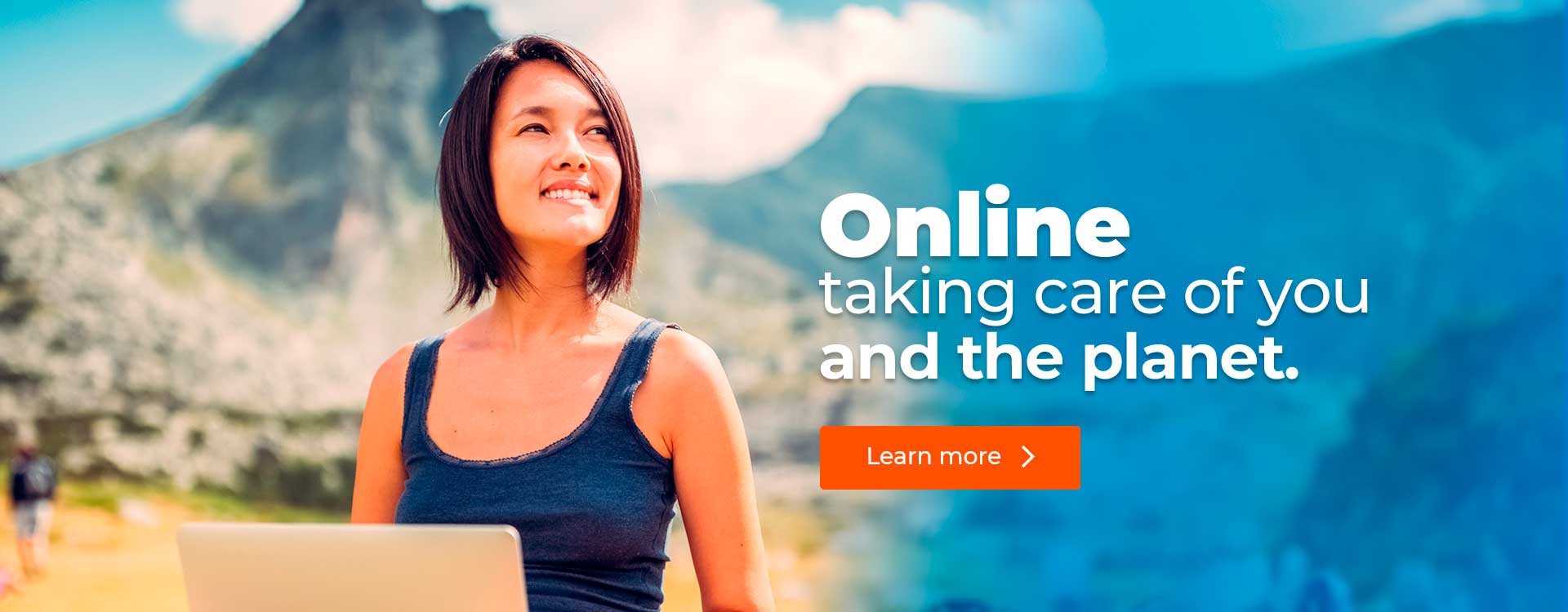 Woman with laptop smiling and looking towards the horizon.