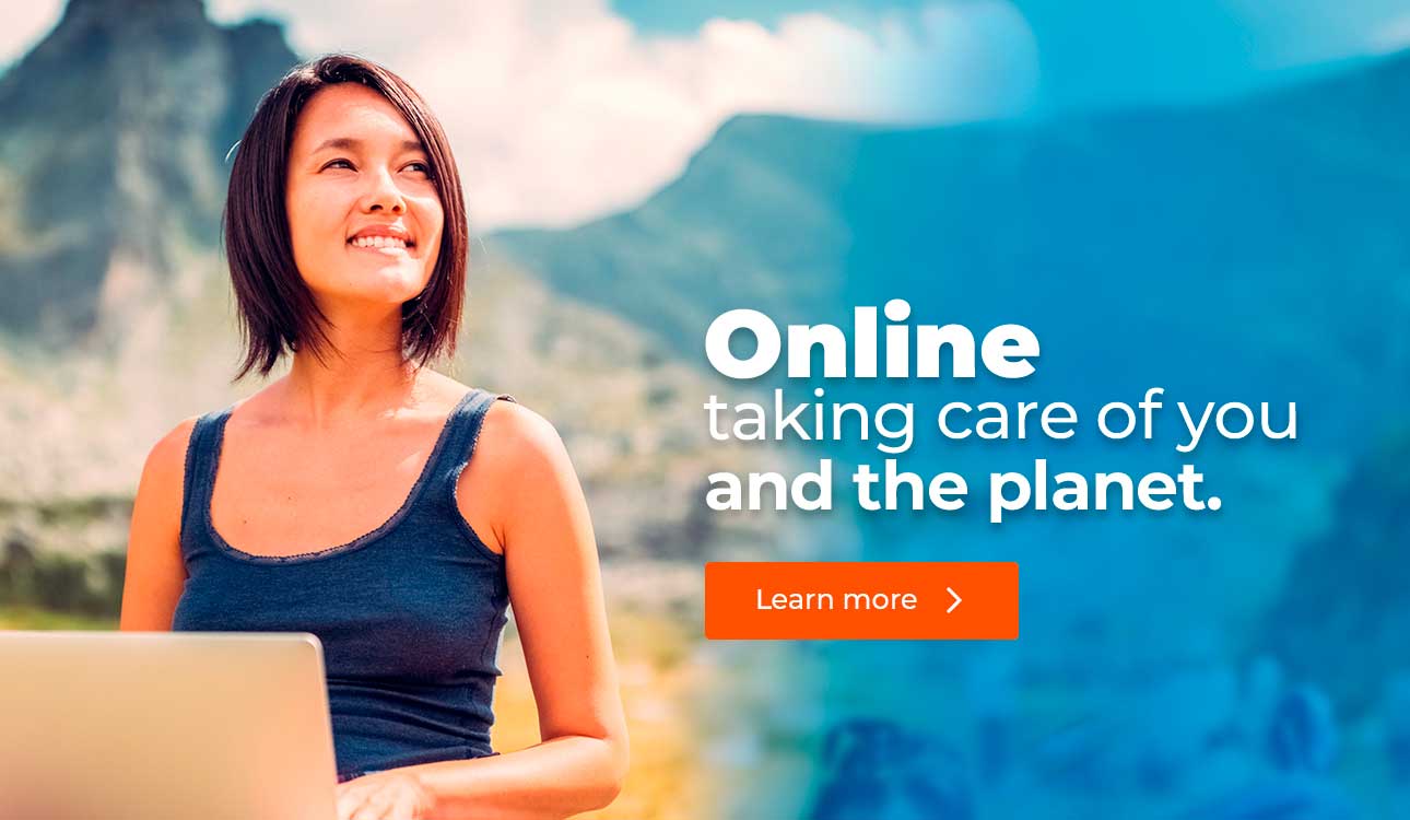 Woman with laptop smiling and looking towards the horizon.