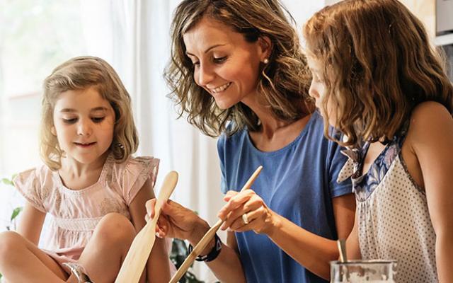 Madre cocinando con sus dos hijas