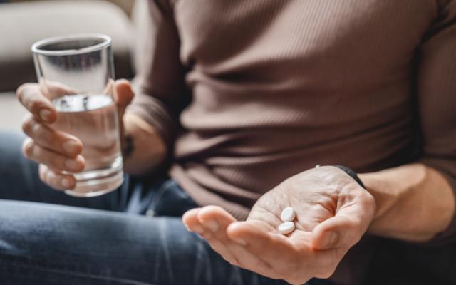 Persona tomando pastillas por indicación médica 