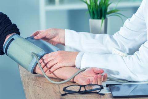 Médico midiendo la presión arterial de un paciente